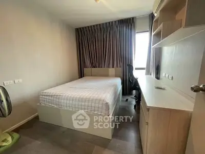 Modern bedroom with sleek furniture and natural light, perfect for urban living.
