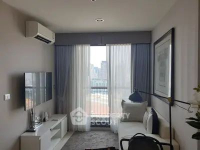 Modern living room with city view, featuring sleek furniture and air conditioning.