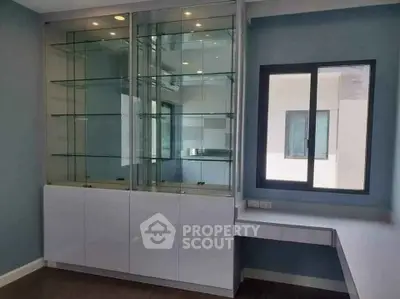 Modern study room with sleek glass display cabinet and built-in desk