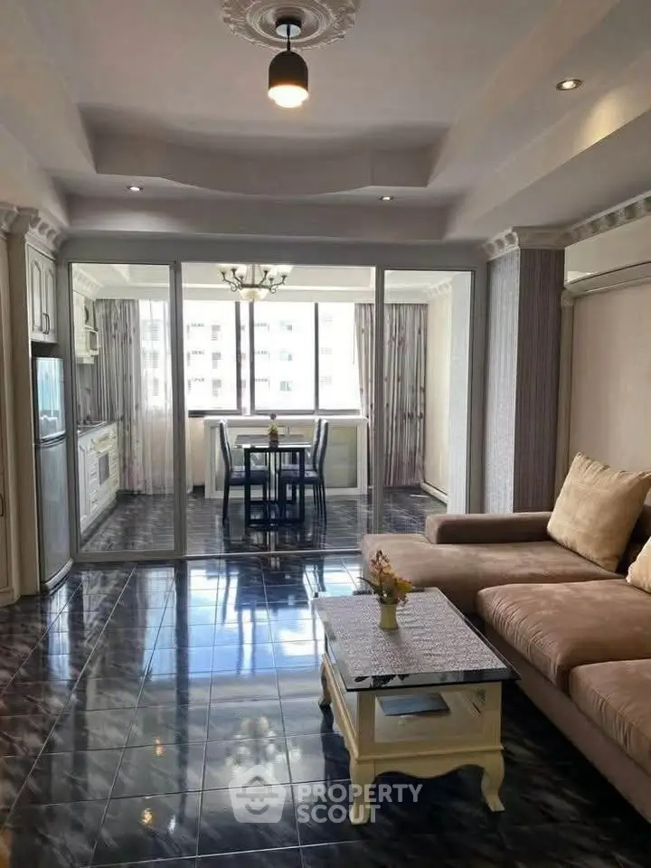 Spacious living room with elegant decor and large windows for natural light.