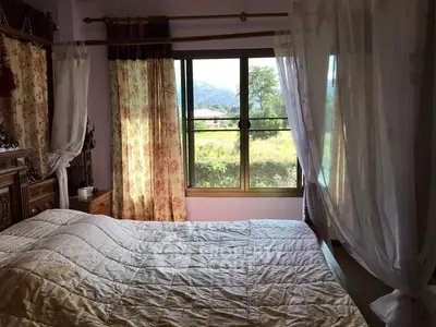 Cozy bedroom with scenic window view and elegant curtains