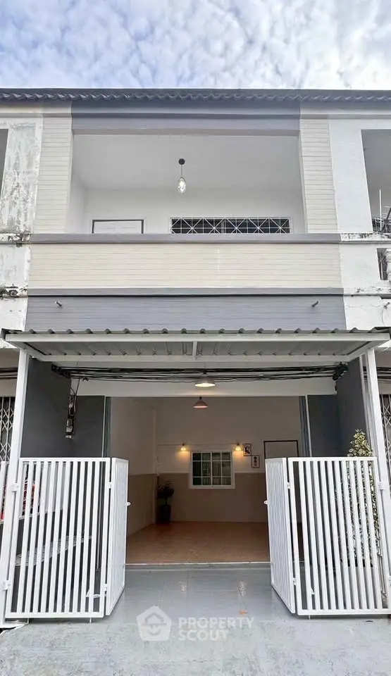 Charming two-story townhouse with gated entrance and spacious garage, perfect for modern living.
