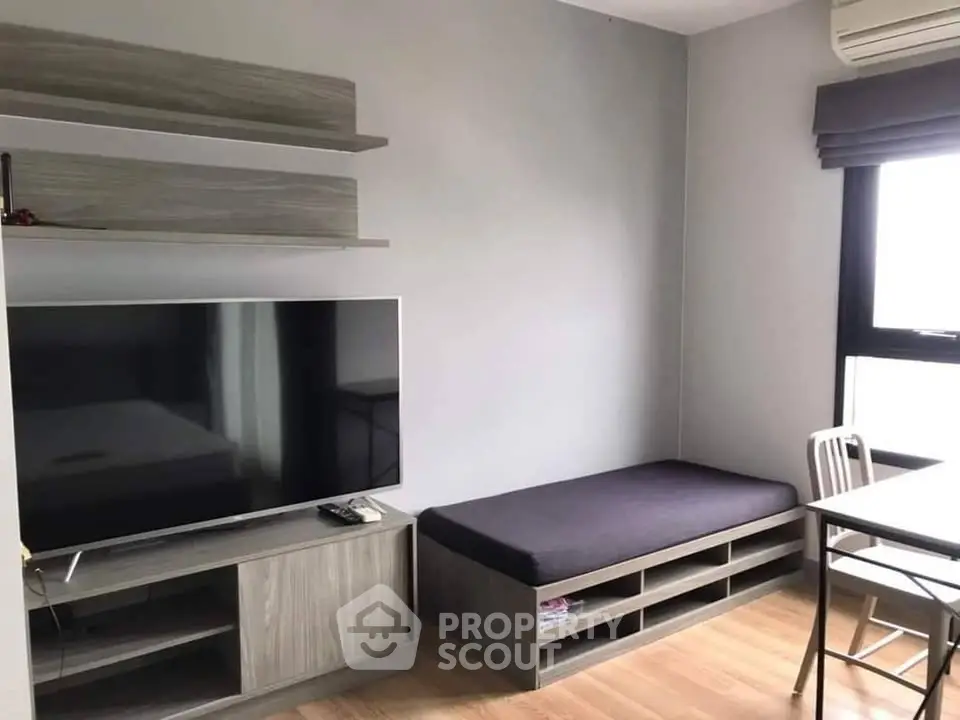 Modern living room with sleek furniture and large TV, perfect for cozy relaxation.
