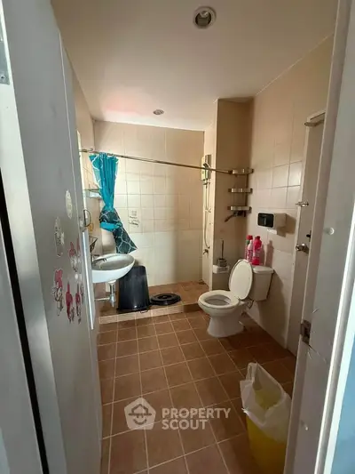Spacious bathroom with modern fixtures and tiled flooring