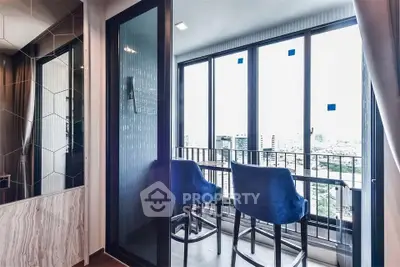 Modern apartment balcony with city view and stylish blue chairs