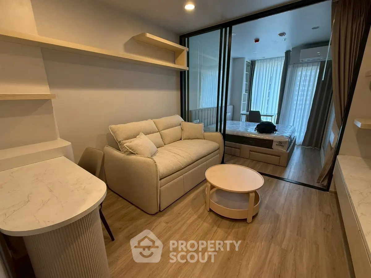 Modern living room with cozy sofa and stylish decor in open-plan apartment