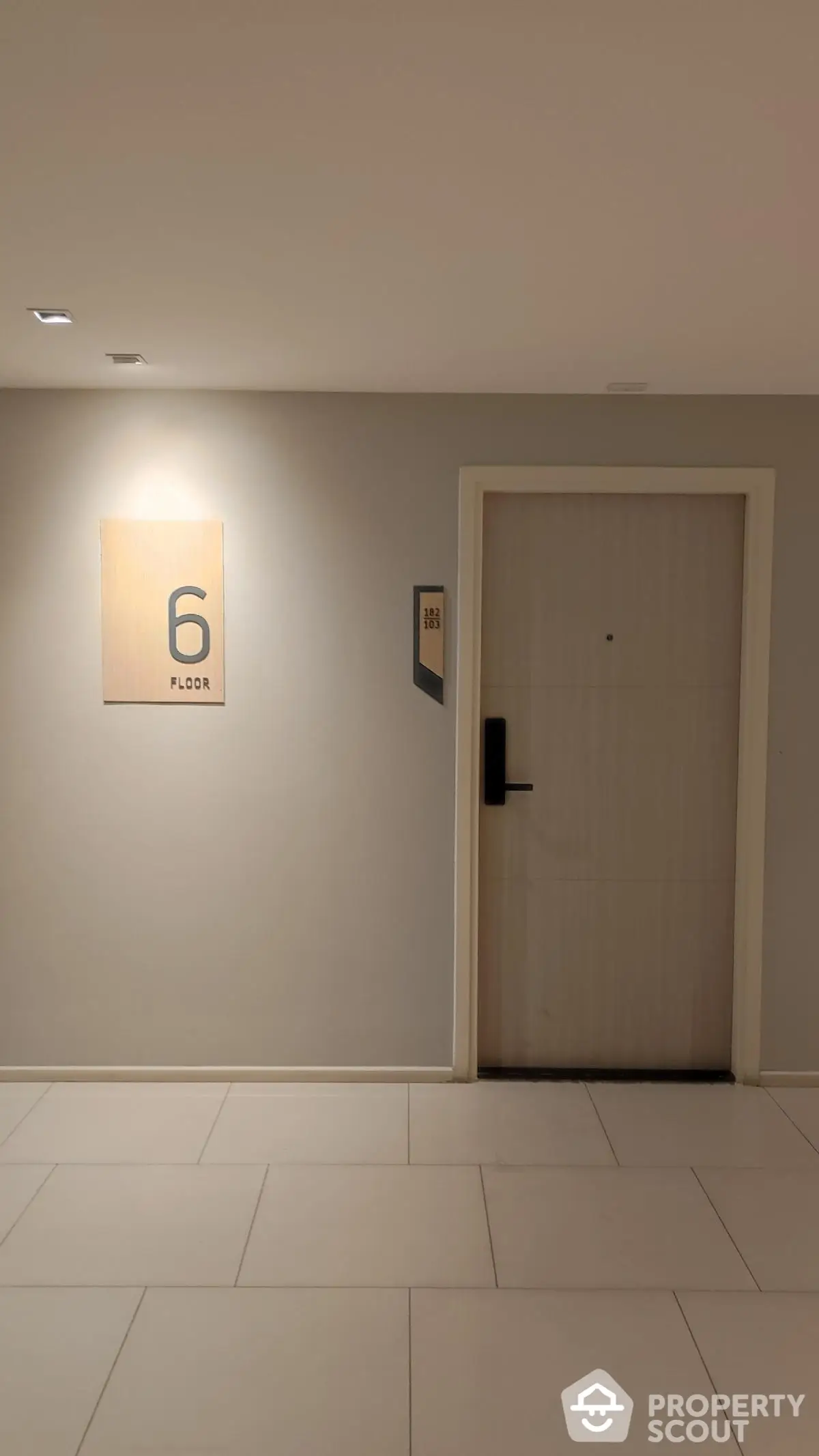 Modern apartment hallway with door and floor number signage