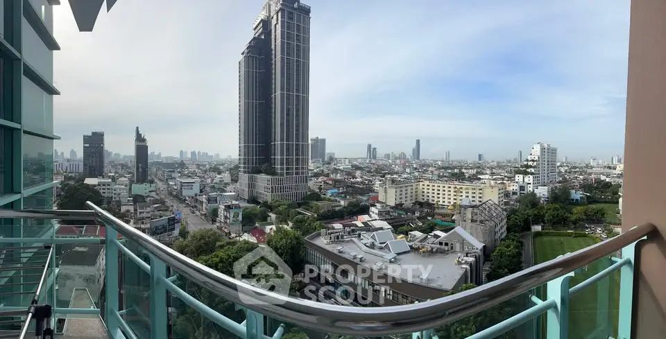 Stunning cityscape view from a high-rise balcony, showcasing urban skyline and modern architecture.