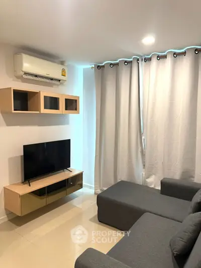 Modern living room with sleek furniture and air conditioning unit