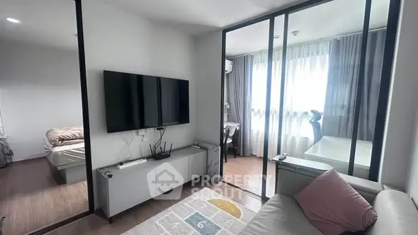 Modern living room with sleek TV setup and glass partition to study area