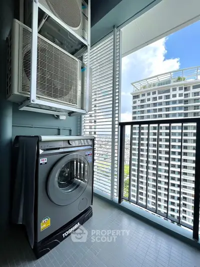 Modern balcony with washing machine and city view in high-rise apartment