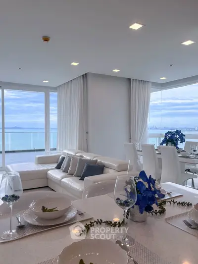 Luxurious living room with ocean view and elegant dining area in modern apartment
