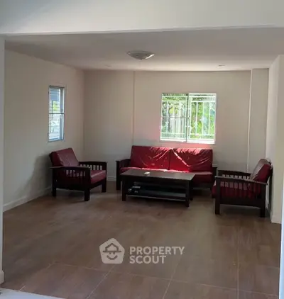 Spacious living room with modern furniture and large windows for natural light