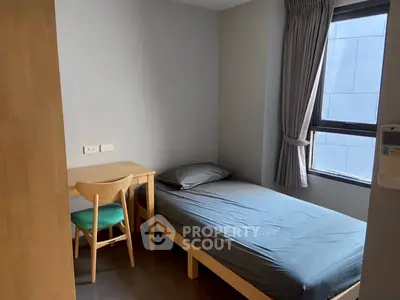 Cozy minimalist bedroom with single bed and study desk, ideal for urban living.