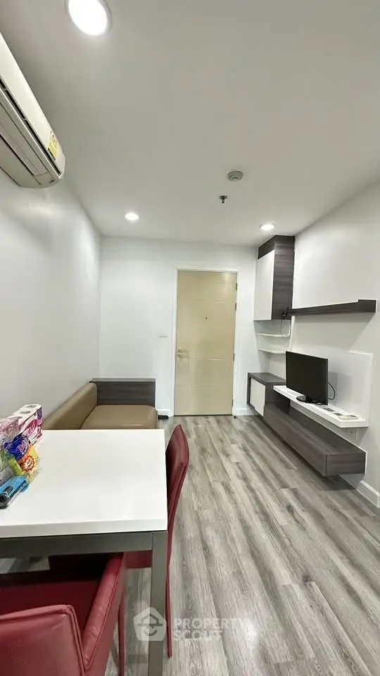 Modern living room with sleek furniture and stylish flooring in a contemporary apartment.