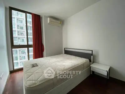 Modern bedroom with large window and minimalist design in urban apartment