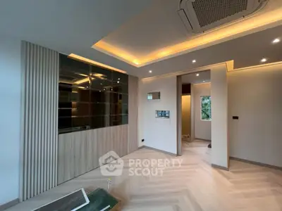 Modern living room with elegant lighting and wood accents