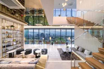 Luxurious modern living room with panoramic city view and elegant staircase