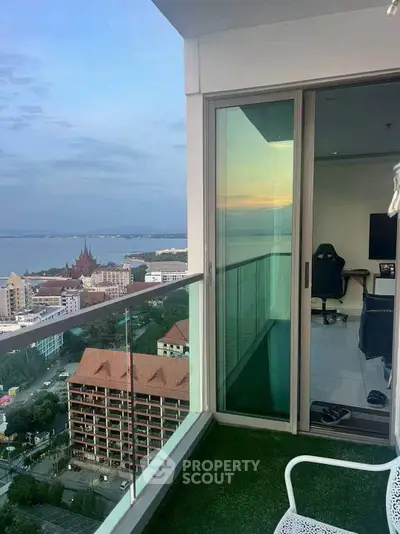 Stunning high-rise balcony with breathtaking city and ocean views, perfect for relaxation.