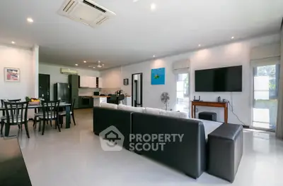 Spacious modern living room with open kitchen and sleek furnishings