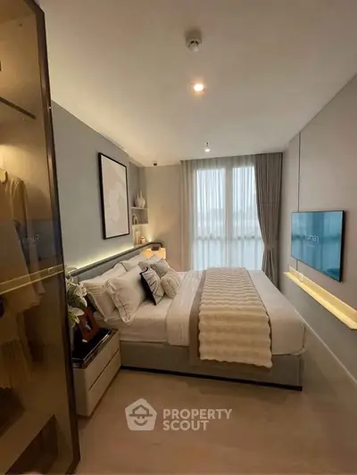 Modern bedroom with elegant decor, large window, and cozy bedding in a stylish apartment.