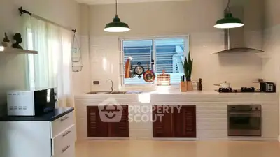 Modern kitchen with sleek white cabinetry and stainless steel appliances