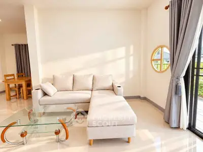 Spacious living room with modern furniture and large windows for natural light.