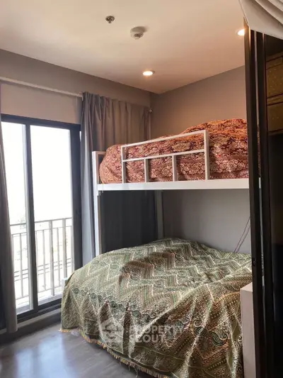 Cozy bedroom with bunk bed and large window for natural light