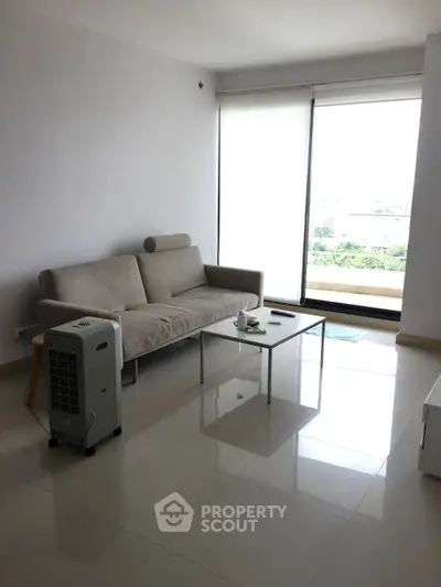 Modern minimalist living room with large window and sleek furniture