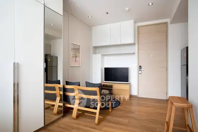 Modern living room with wooden flooring and sleek furniture in a stylish apartment.