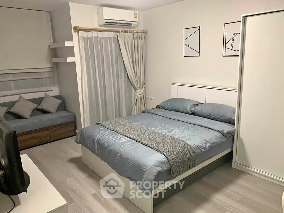Modern bedroom with stylish decor and cozy ambiance, featuring a comfortable bed and sleek furnishings.