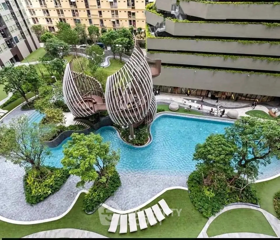 Luxurious modern apartment complex with stunning pool and lush landscaping