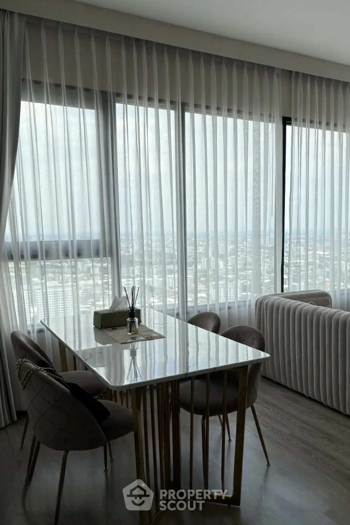 Luxurious high-rise dining area with panoramic city views and elegant decor.
