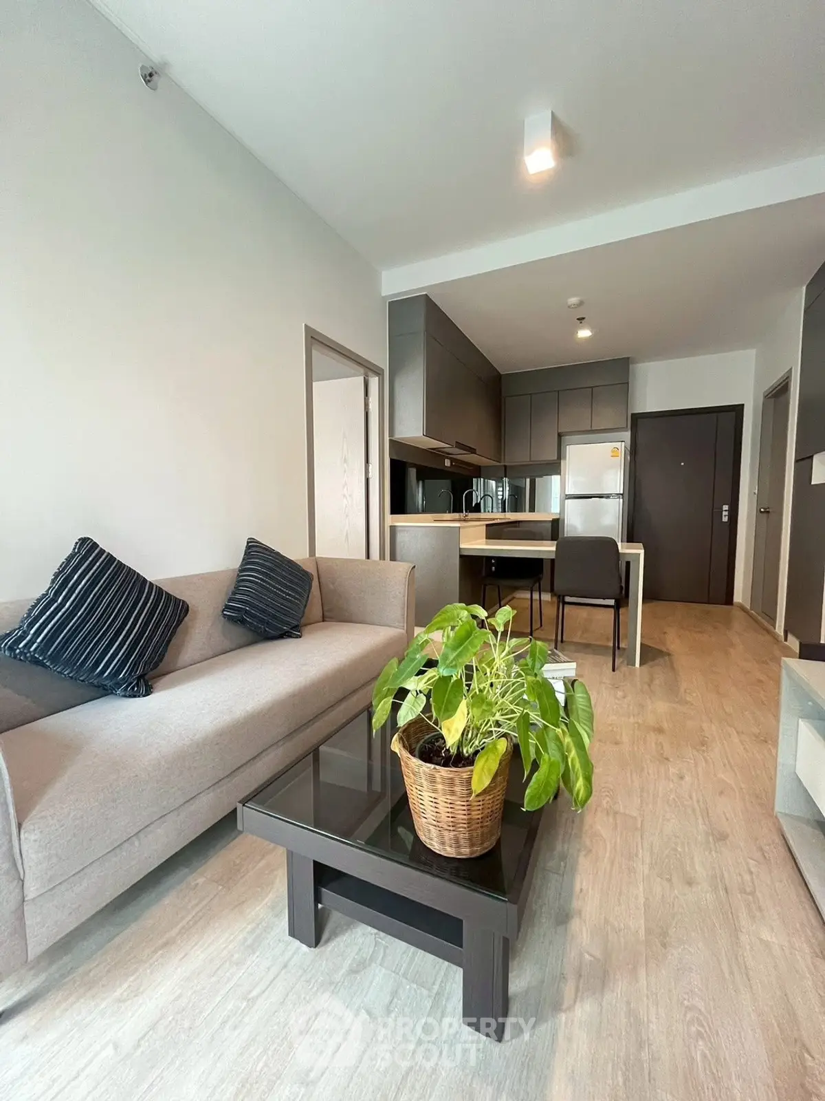 Modern living room with sleek furniture and open kitchen layout