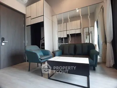 Modern living room with stylish furniture and large mirror enhancing space