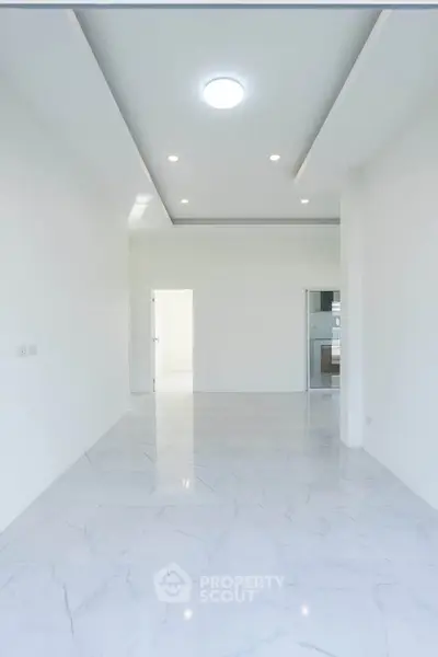 Spacious modern living room with sleek marble flooring and recessed lighting