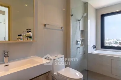 Modern bathroom with sleek fixtures and city view from large window
