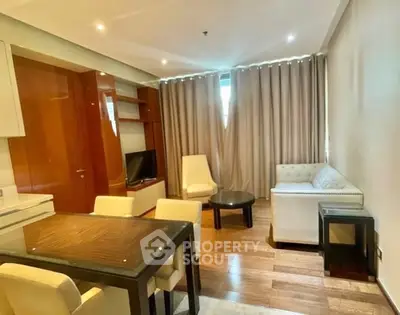 Modern living room with elegant furniture and wooden flooring in a cozy apartment.