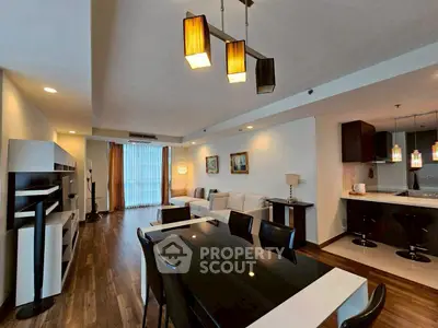 Spacious modern living room with open kitchen and elegant lighting in a stylish apartment.