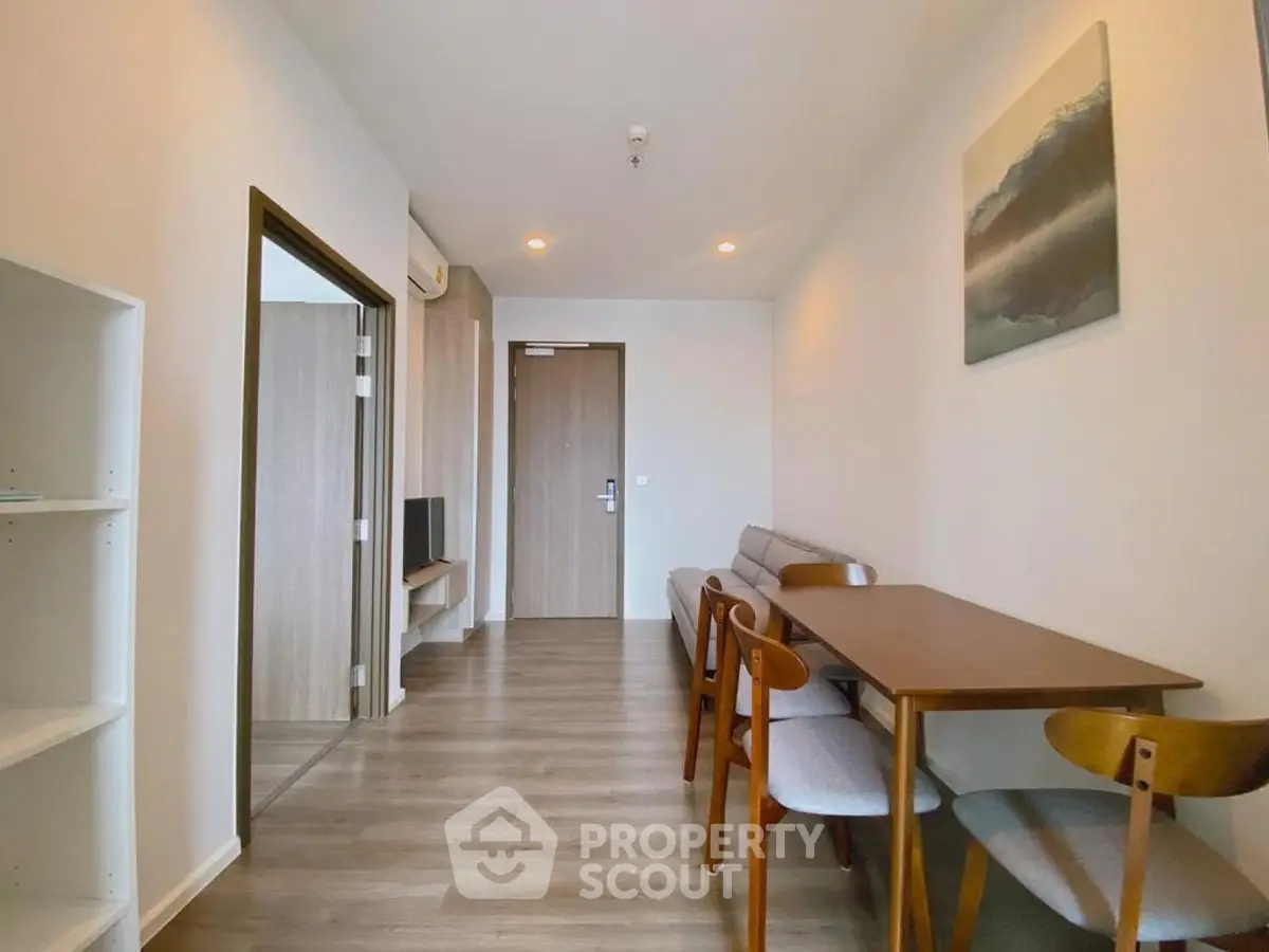 Modern living room with dining area and stylish furniture in a contemporary apartment.