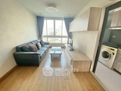 Modern living room with large window and sleek furniture in urban apartment