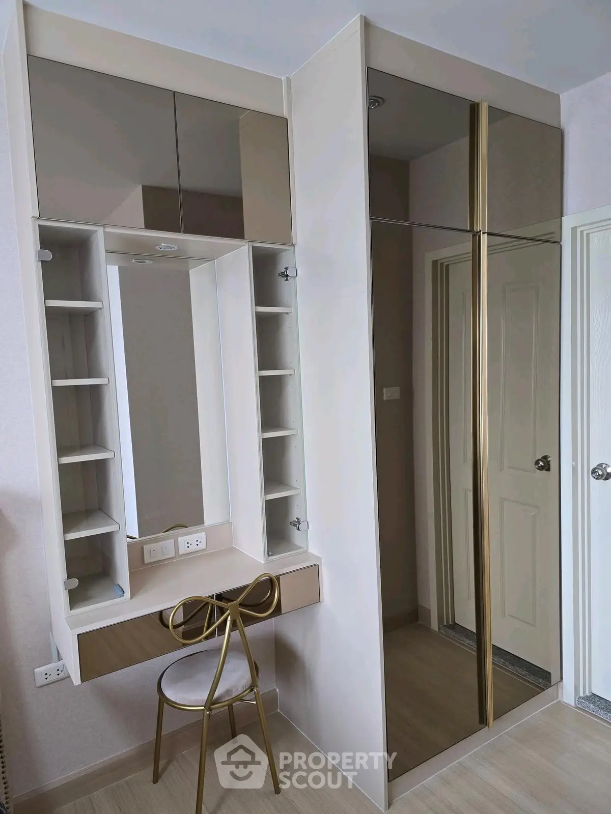 Modern bedroom with stylish vanity and mirrored wardrobe