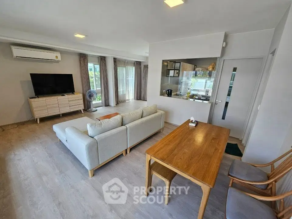 Spacious living room with modern decor and large windows for natural light.