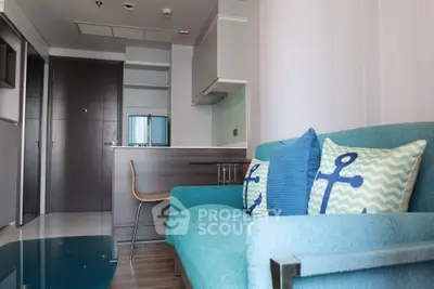 Modern living room with stylish blue sofa and chic decor in a contemporary apartment.