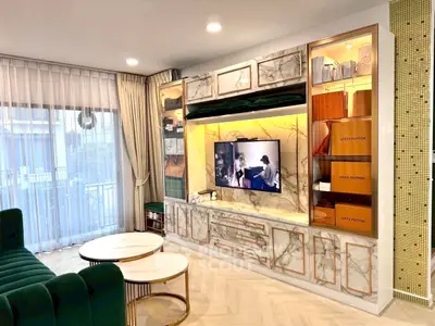 Luxurious living room with marble TV wall and elegant decor