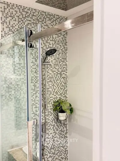 Modern bathroom with stylish mosaic tiles and sleek shower design