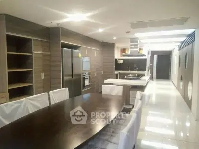 Modern kitchen with sleek design, featuring stainless steel appliances and elegant dining area.