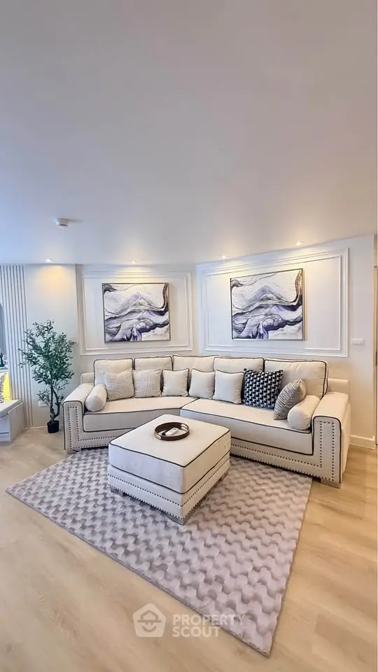 Elegant living room with plush beige sofa, stylish decor, and cozy ambiance, perfect for relaxation and entertaining.