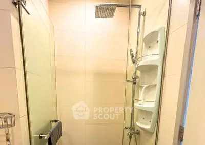 Modern bathroom with glass shower enclosure and sleek fixtures