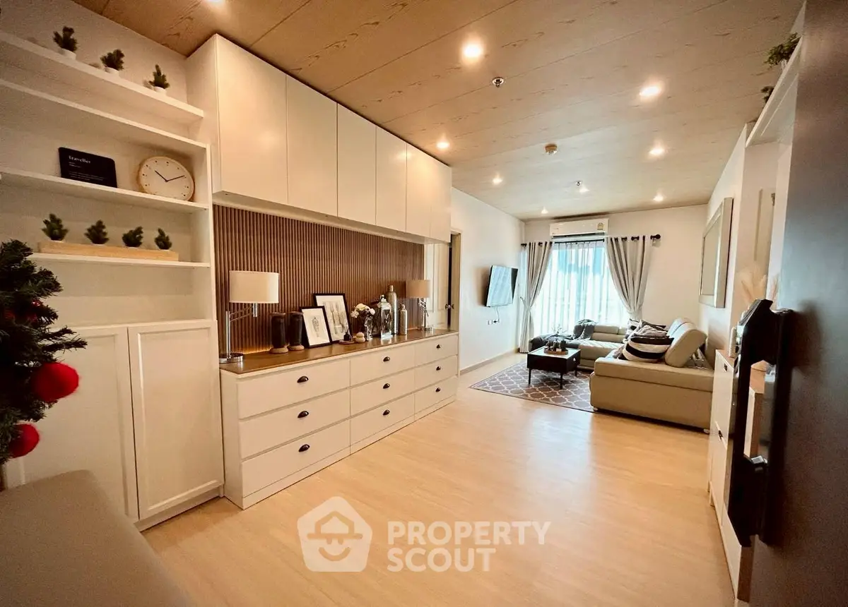 Spacious living room with modern decor and ample natural light, perfect for relaxation and entertainment.